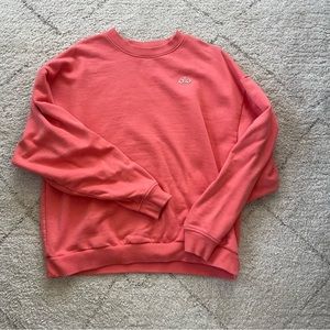 Alo accolade crewneck candy orange